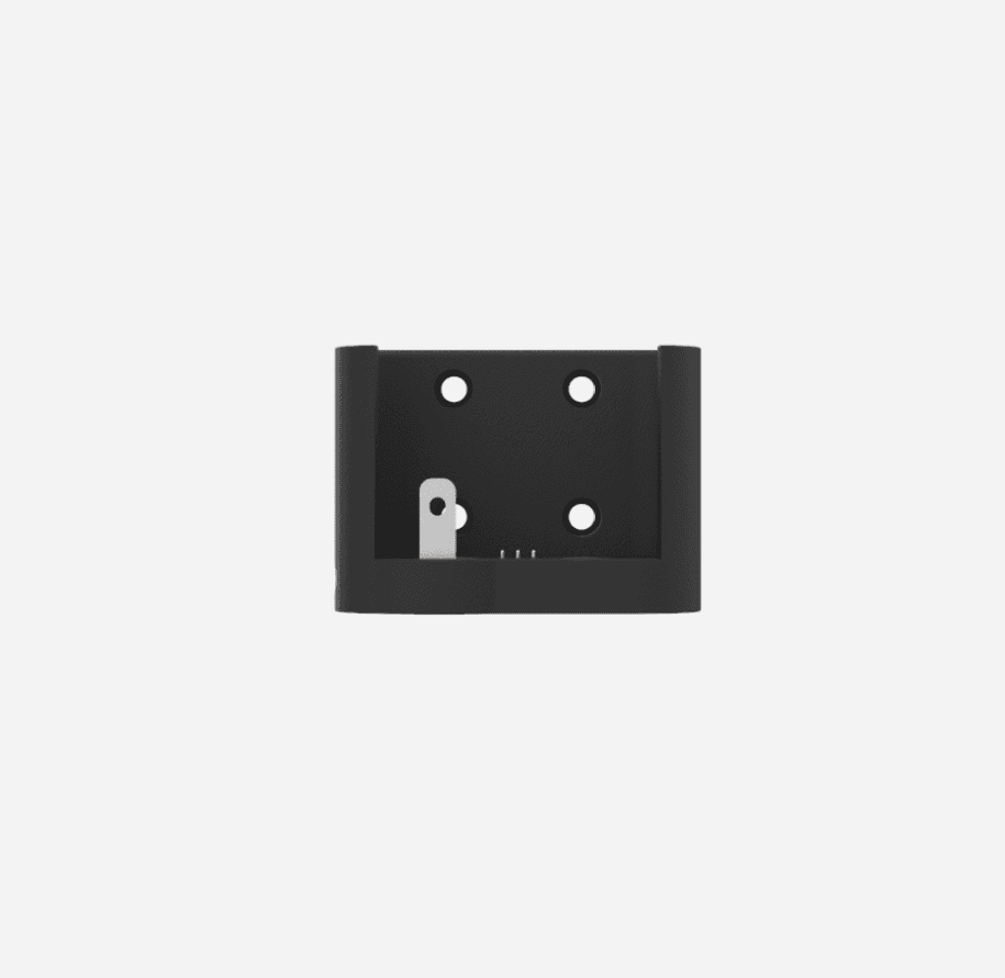 The Reach 2 charging mount face on: a black plate with four screw holes and the three charging contacts